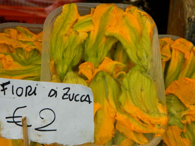 Zucchini blossoms at a farmers market in Tuscany.